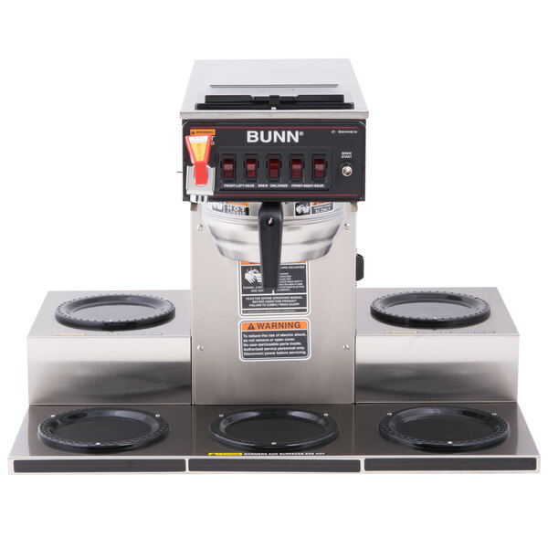 A Bunn automatic coffee brewer with stainless steel funnel and black warmers.