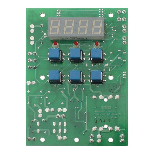 A green circuit board with blue and red squares and a digital display.