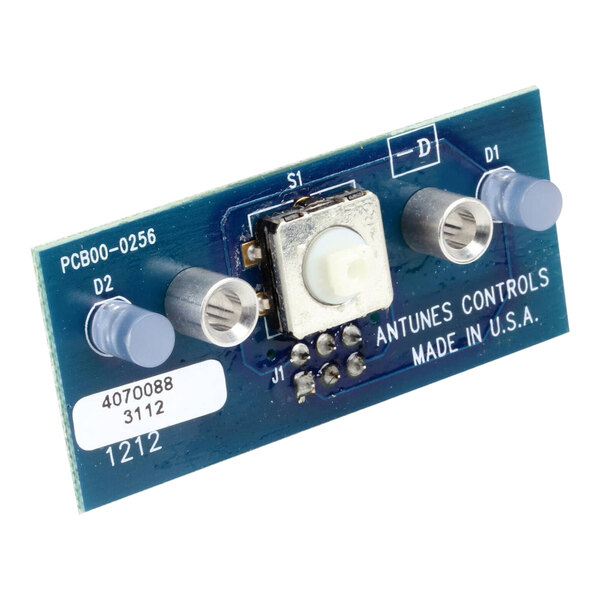 A small blue circuit board with a white button on a metal object.