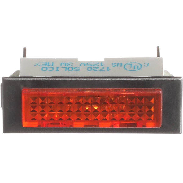 A close up of a red rectangular Crown Steam pilot light with squares on a white background.