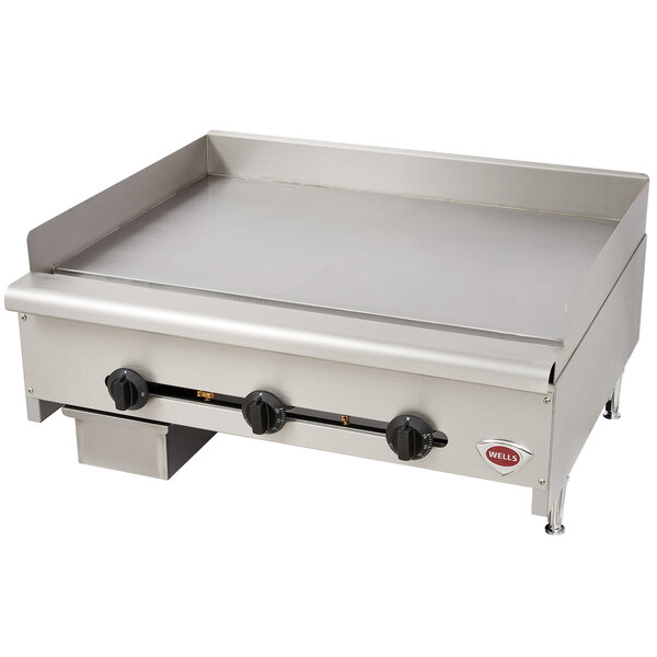 A Wells heavy duty stainless steel countertop griddle with three burners.