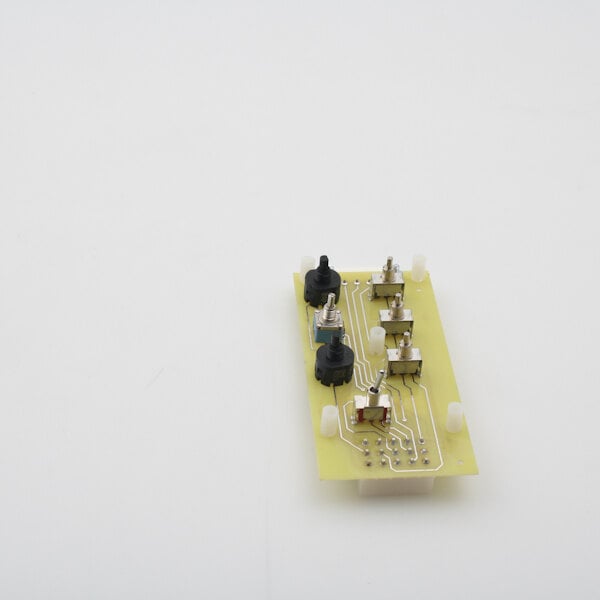 A small yellow Perlick 50453 chemical system circuit board with many small metal parts.