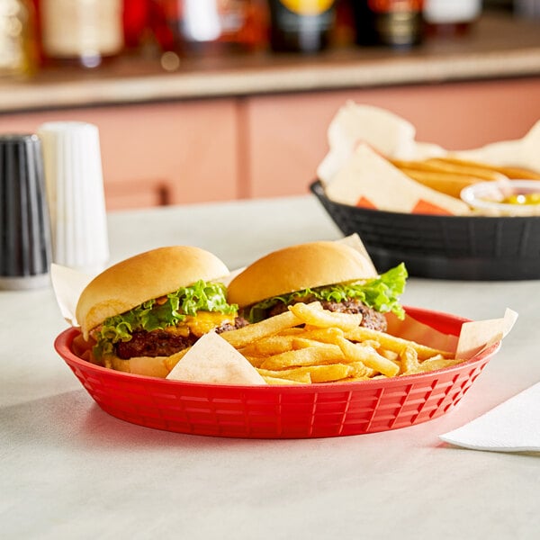 A red Tablecraft diner platter holding two hamburgers and a basket of fries.