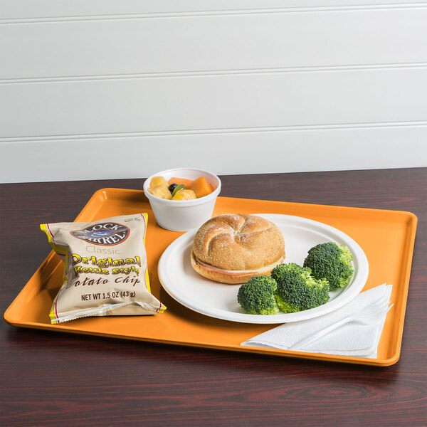 A Cambro Tuscan Gold dietary tray with a sandwich, broccoli, and a drink on it.