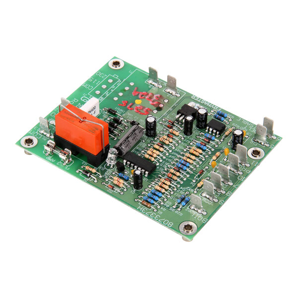A green Frymaster PCB with many components on it.