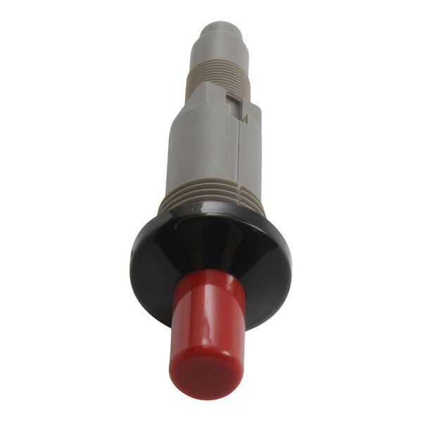 A red and black plastic button with a grey and red electrical device.