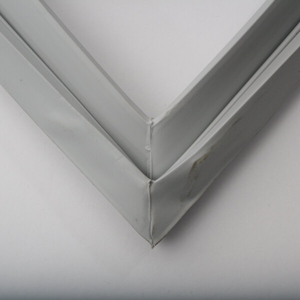 A close-up of a white metal Delfield gasket frame.