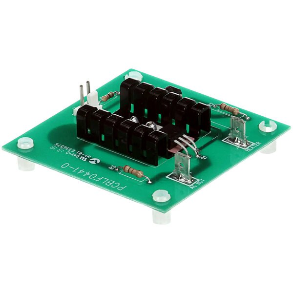 A green circuit board with black and white objects and text.