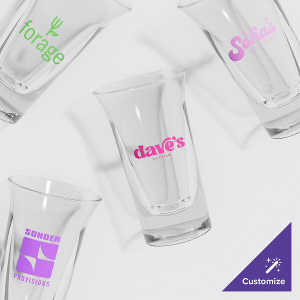 A group of empty GET SAN plastic dessert shot glasses with a custom logo.