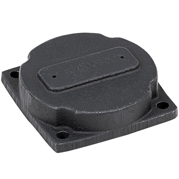 A black metal square cover with a hole in the middle.