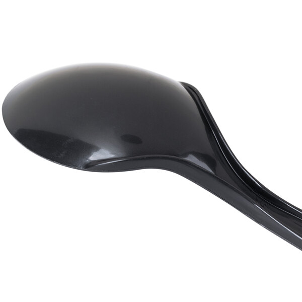 A black plastic spoon with a white background.