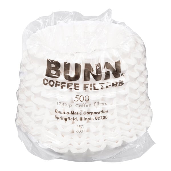 A package of white, fluted coffee filters wrapped in clear plastic with printed text on the packaging.
