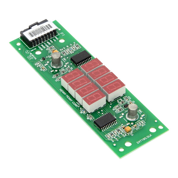 A green circuit board with many small red and white objects.