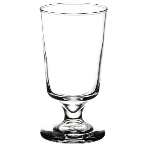 A Libbey footed highball glass with a small rim on top.