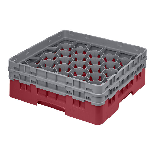 A red and grey plastic Cambro glass rack with 30 compartments.