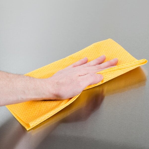 a hand on a yellow towel