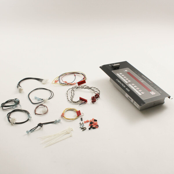A black control board with wires and other items attached.