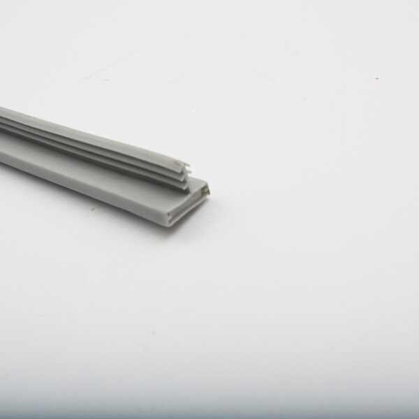 A grey plastic strip with a grey piece of magnetic material.