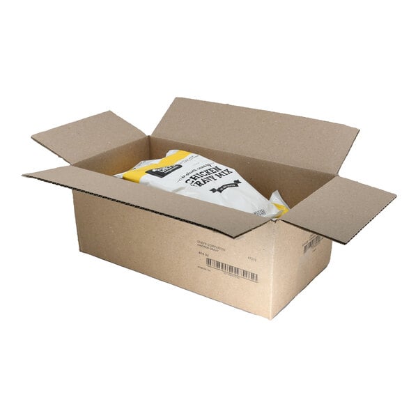 A white cardboard box with a yellow package of Chef's Companion Chicken Gravy mix inside.