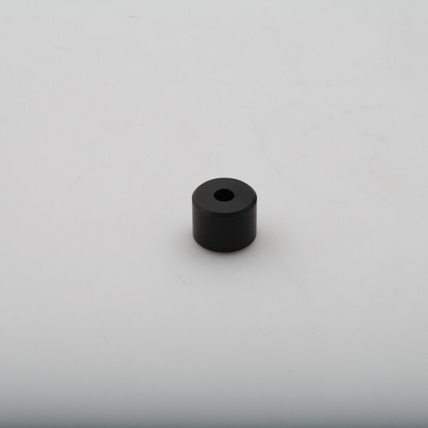 A black rubber Blakeslee roller on a white surface.