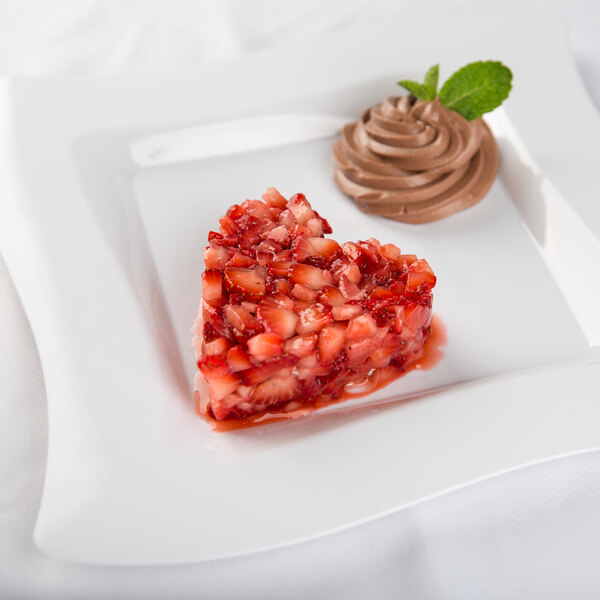 A heart shaped dessert on a white plate.