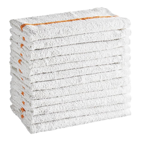 A stack of twelve folded white towels with a gold stripe along the edge.