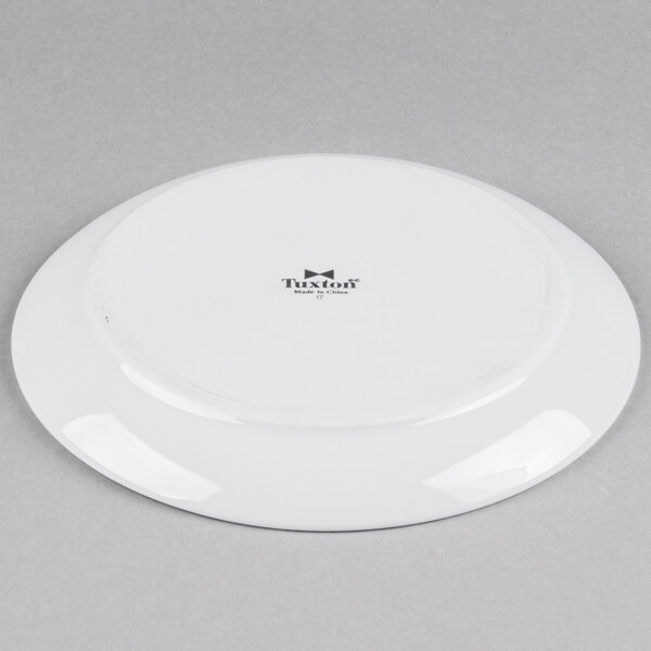 A Tuxton bright white china plate with a white rim.
