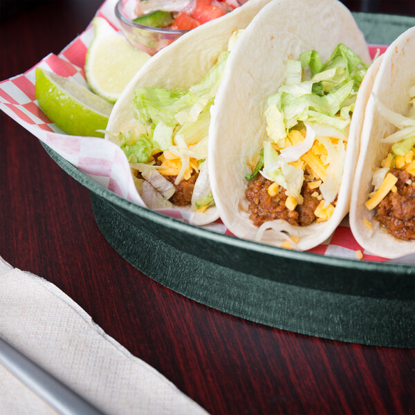 A plate of tacos in a HS Inc. jalapeno deli server on a table with a lime wedge.
