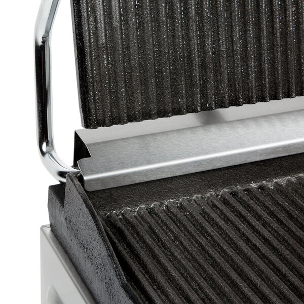 A Cecilware single panini grill with grooved grill surfaces on a counter in a professional kitchen.