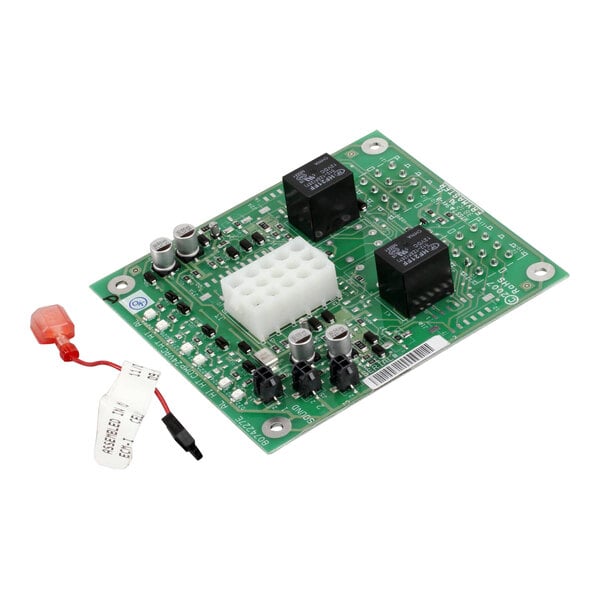 A green circuit board with a black square object and white tag with black text.