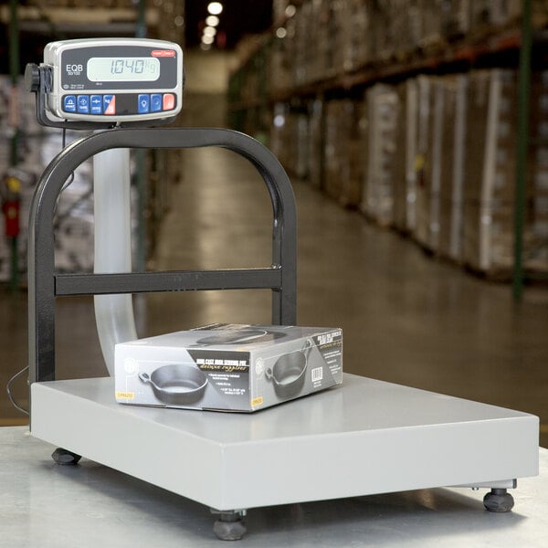 A Tor Rey digital receiving bench scale with a tower display on a table.