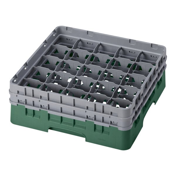 A green and gray plastic Cambro glass rack with many compartments.