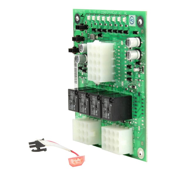 A green Frymaster circuit board with two wires and a power switch.