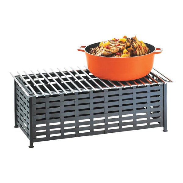 A rectangular black iron chafer alternative with a metal grate top, shown holding an orange pot of food.