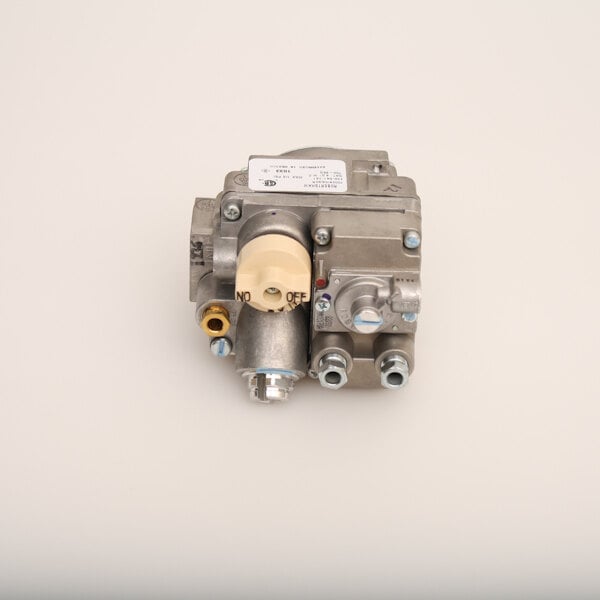 A close-up of a Pitco gas valve with a white label on top.