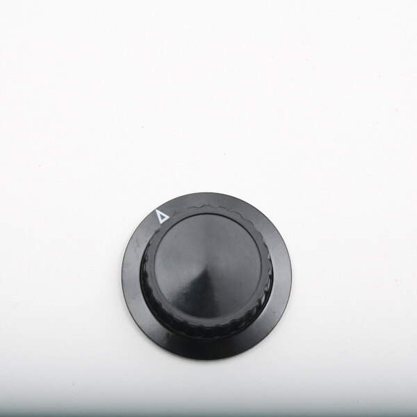 A black Winston Industries Inc. knob with a triangle on a white surface.