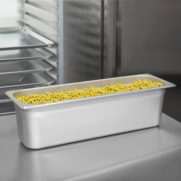 A Choice stainless steel steam table pan filled with yellow corn on a counter.