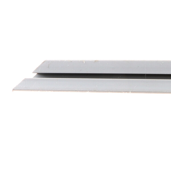 A close-up of two metal gasket retainers on a white surface