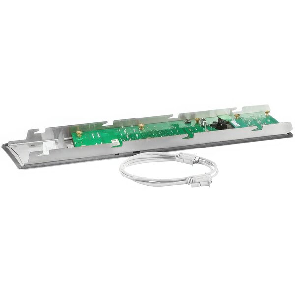 A green and silver electronic board with a white cable attached.