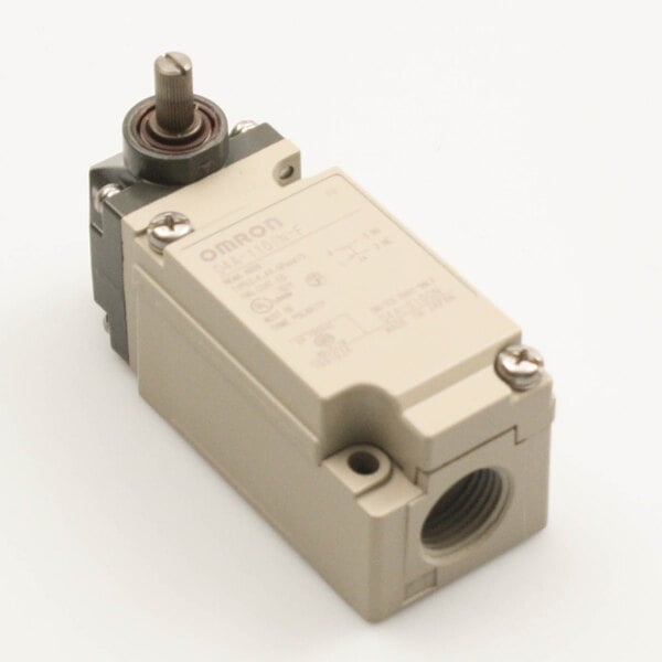 A close-up of a small grey and black microswitch on a metal rack.