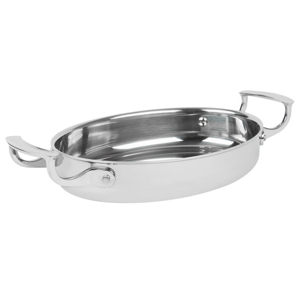 A stainless steel Vollrath oval au gratin pan with handles.