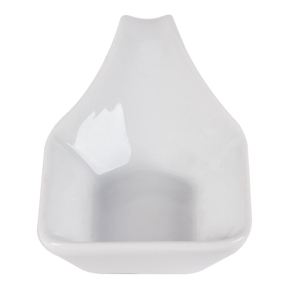 A white porcelain spoon with a handle.