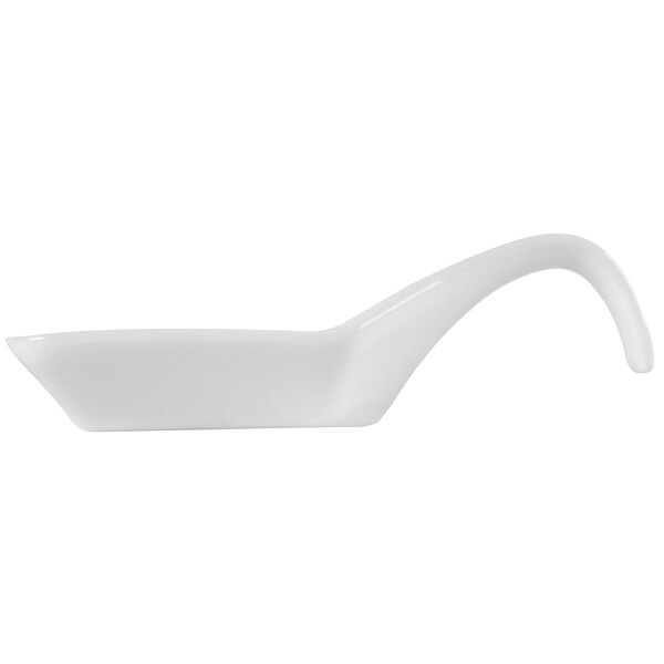A white porcelain spoon with a curved handle.