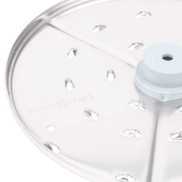 A Robot Coupe 1/8" grating/shredding disc with holes in it.