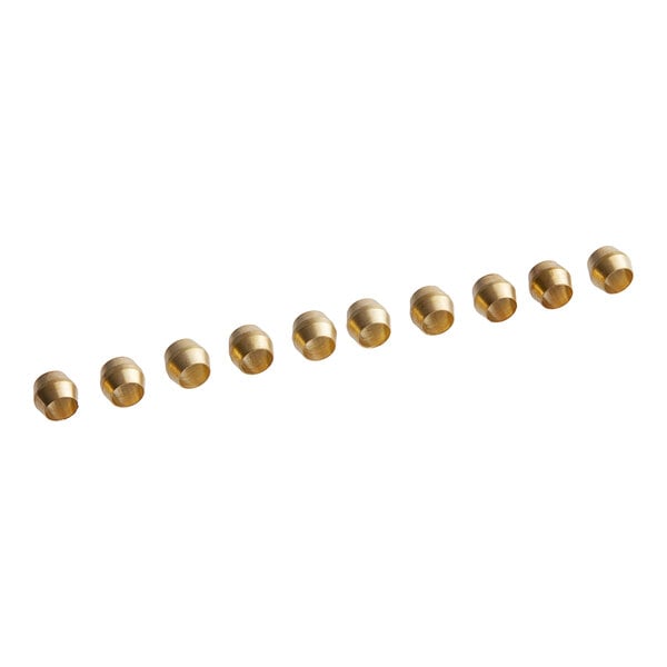 A row of gold colored metal ferrules on a white background.