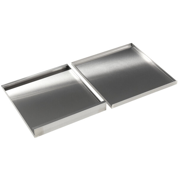 Two stainless steel covers for Silver King refrigeration equipment on a counter.