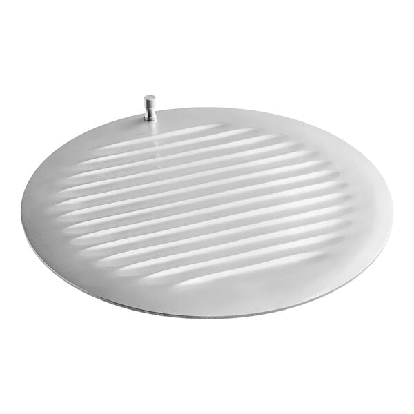 A white metal center plate with a circular design and a screw.