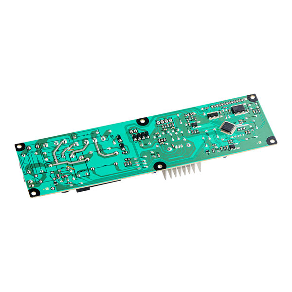 A close-up of a green Turbo Air Refrigeration control board with many small electronic components.