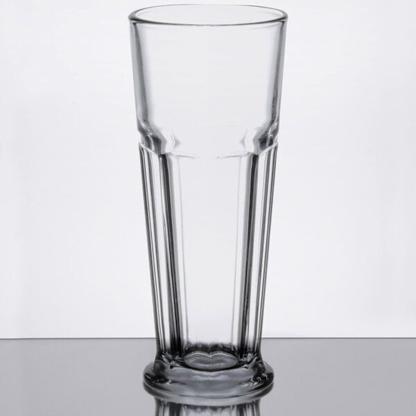 A close-up of a Libbey footed pilsner glass with a clear heart on the bottom.