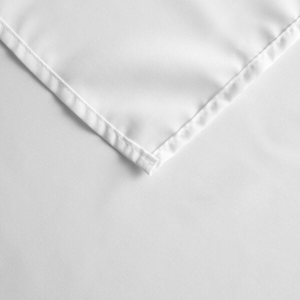 A white rectangular cloth table cover with a hemmed edge.